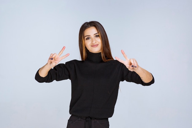 woman in black shirt sending peace and friendship message. 