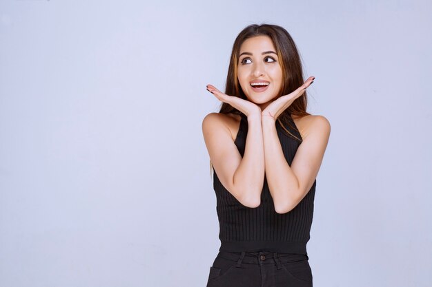 Woman in black shirt smiling. 