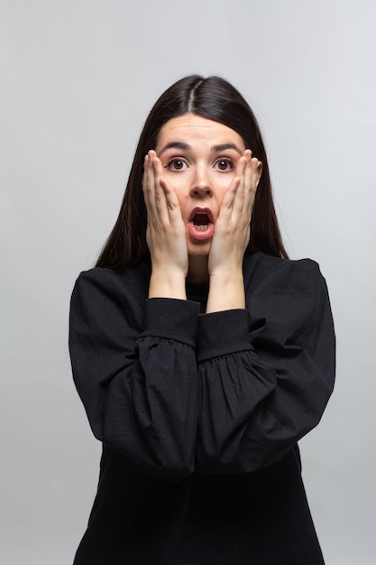 Woman in black sweater demonstrates shame