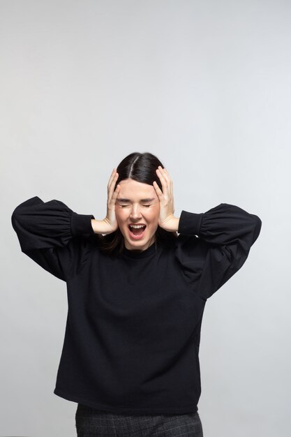 Woman in black sweater shows distress