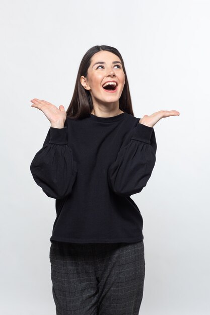 Woman in black sweater shows happiness