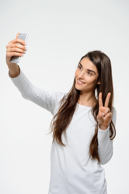 Free photo woman blogger taking selfie on mobile phone