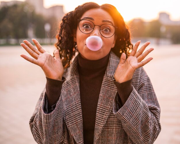 Woman blowing bubbles outdoors