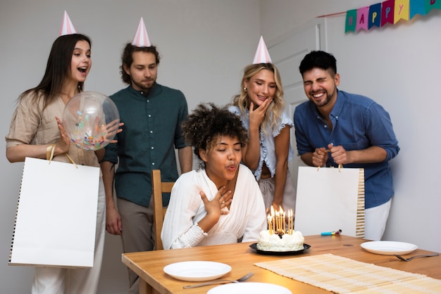 Free photo woman blowing candles side view