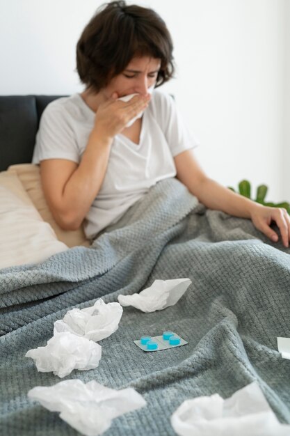 woman blowing her nose medium shot