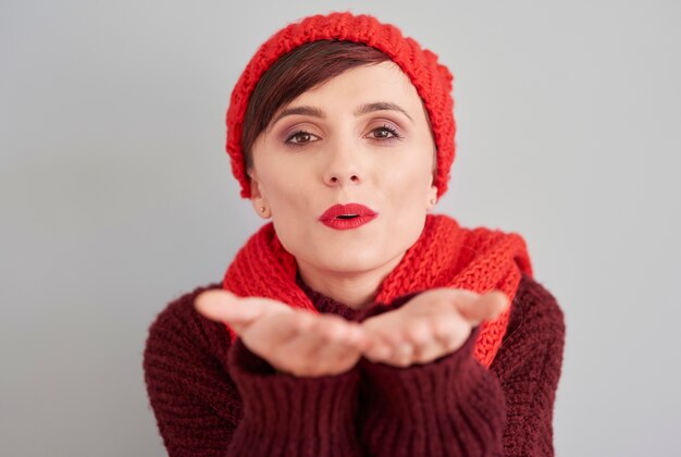 Woman blowing a kiss towards the camera