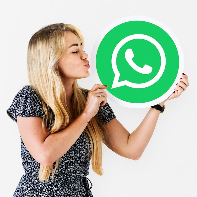 Woman blowing a kiss to a WhatsApp Messenger icon