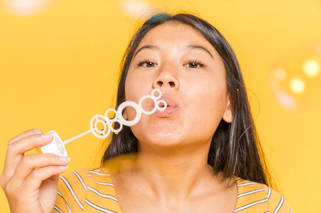 Woman blowing and making bubbles