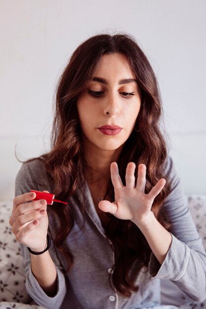 Woman blowing at nails