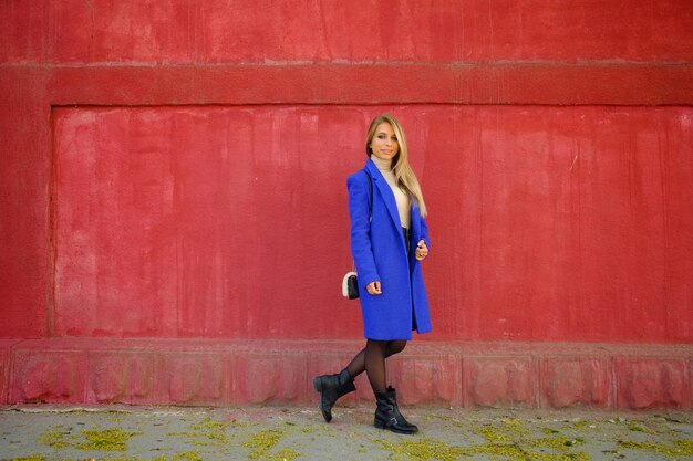 woman in the blue coat on the street