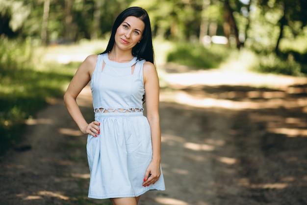 Woman in blue dress in park