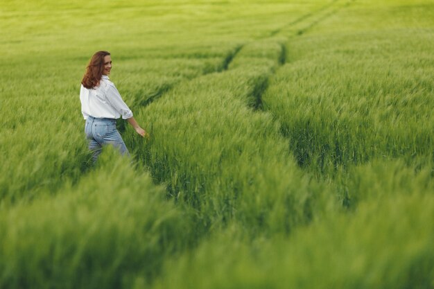 Woman in blue shirt  in a summer field