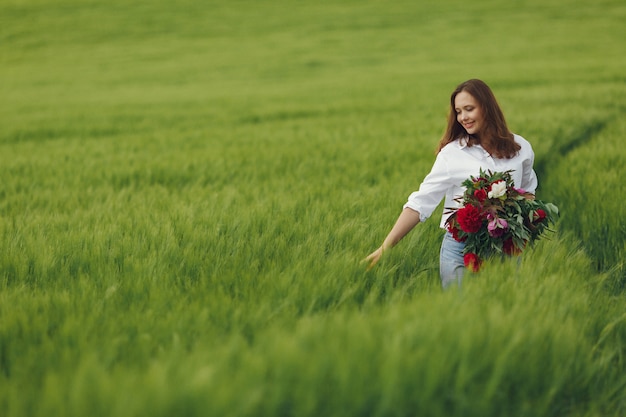 Woman in blue shirt  in a summer field