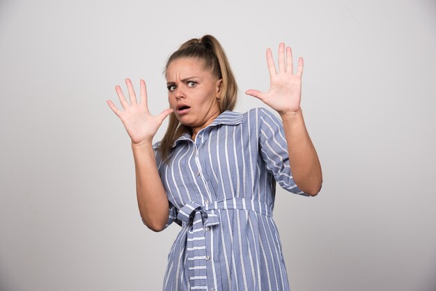 Woman in blue sweater getting scared.