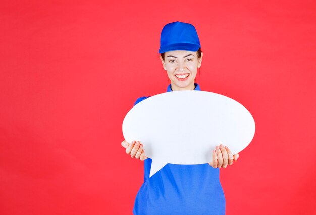 Woman in blue uniform holding an ovale idea board . 