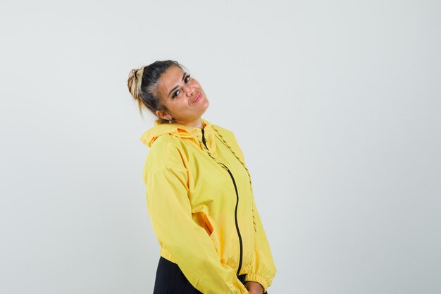 Woman bowing head on her shoulder in sport suit and looking cute , front view.