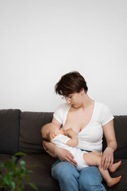 Женщина кормит ребенка грудью