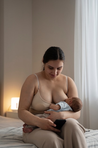 Free photo woman breast feeding her child