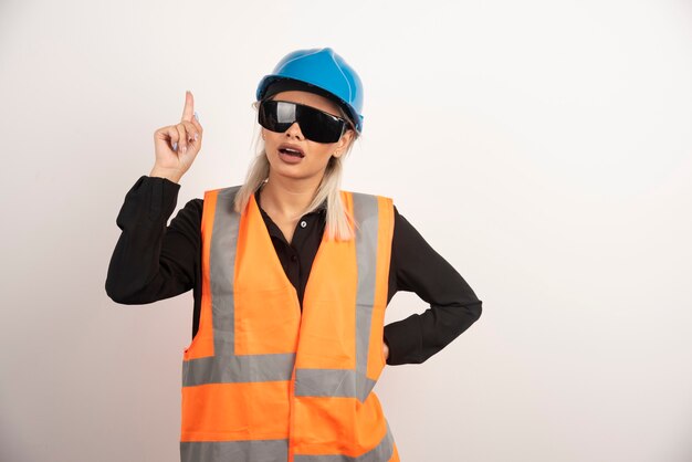 Woman builder showing finger up and posing . High quality photo