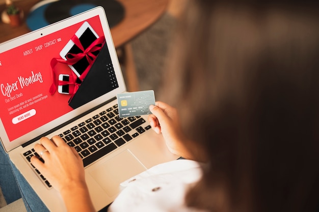 Woman buying with credit card over the shoulder view