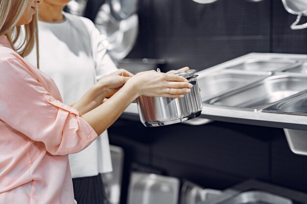 Woman buys dishes in the store