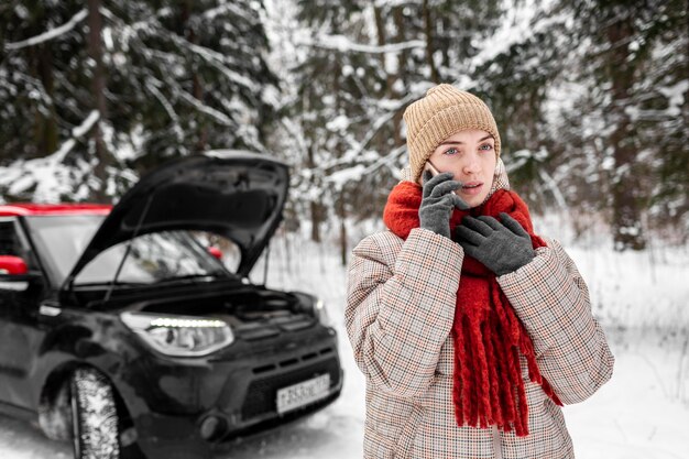 Woman by car talking on mobile