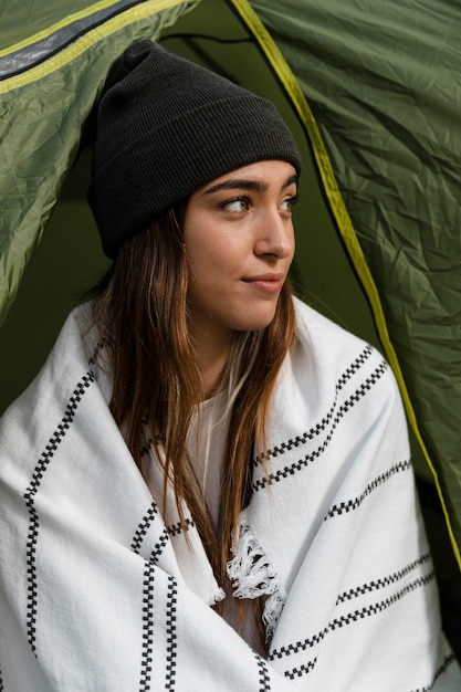 Woman camping and looking away