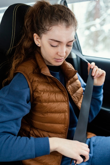 Woman in car buckle up safety belt