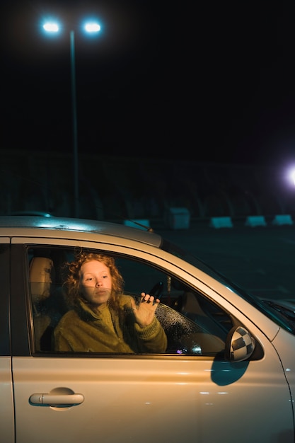 Woman in car at nicht