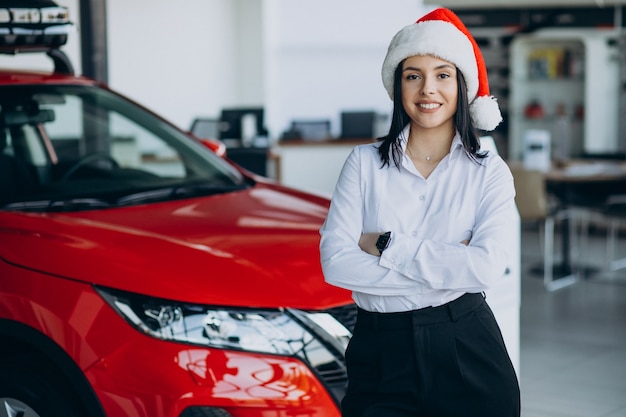 Woman in a car showroom on christmas