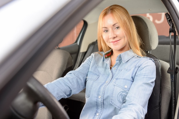 Free photo woman in car with massage seat cushion