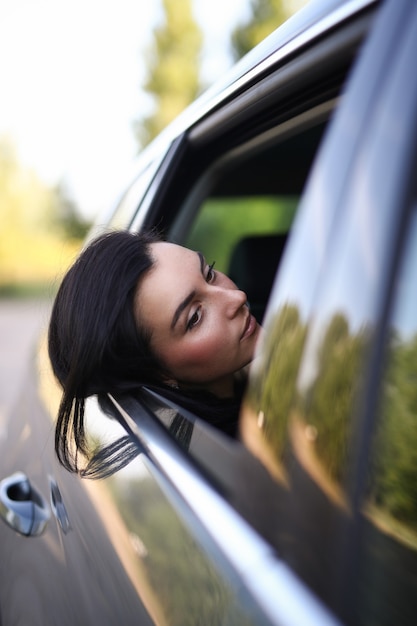 Free photo woman in a car