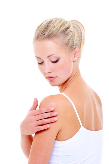 Woman care massaging her shoulder over white space