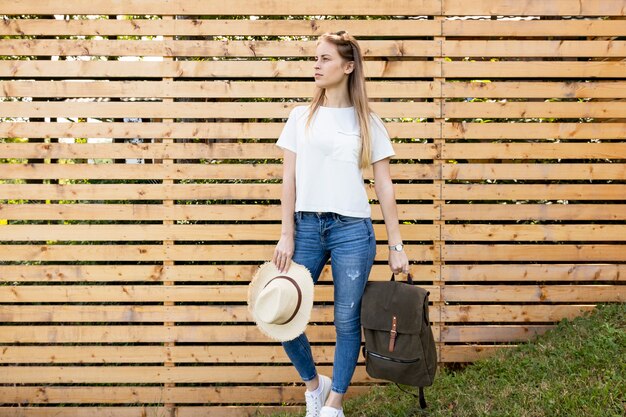 Woman carrying her backpack and looking away