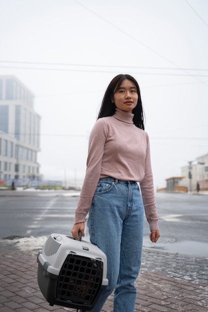 Woman carrying her pet in the street