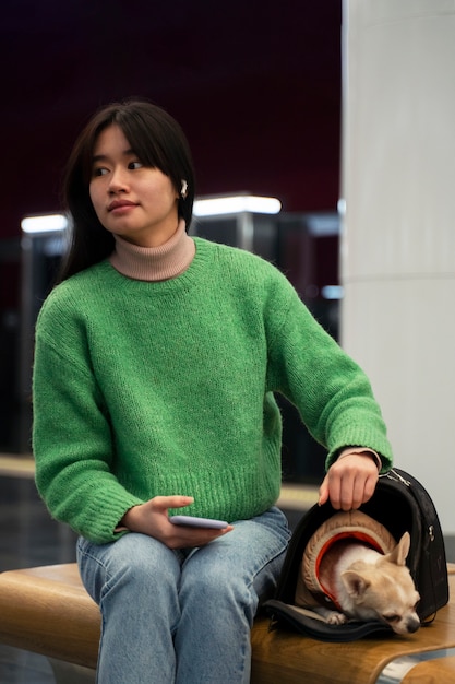 Free photo woman carrying her pet in the subway