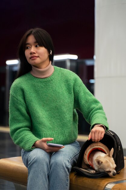 Woman carrying her pet in the subway