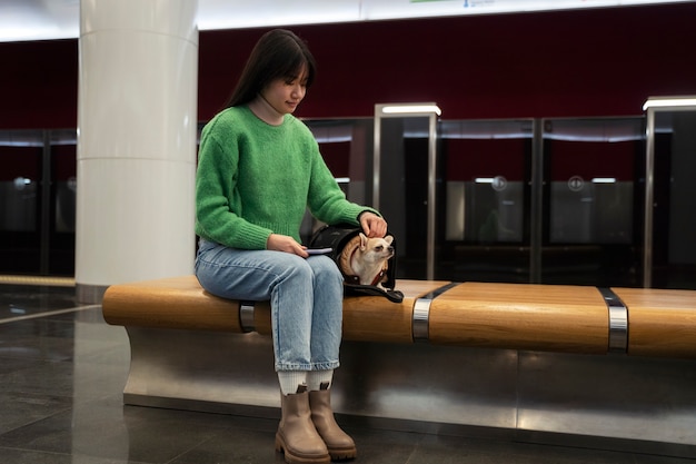 Woman carrying her pet in the subway