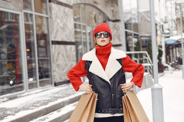 Woman carrying shopping bags at an outdoor shopping mall