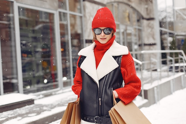 Woman carrying shopping bags at an outdoor shopping mall