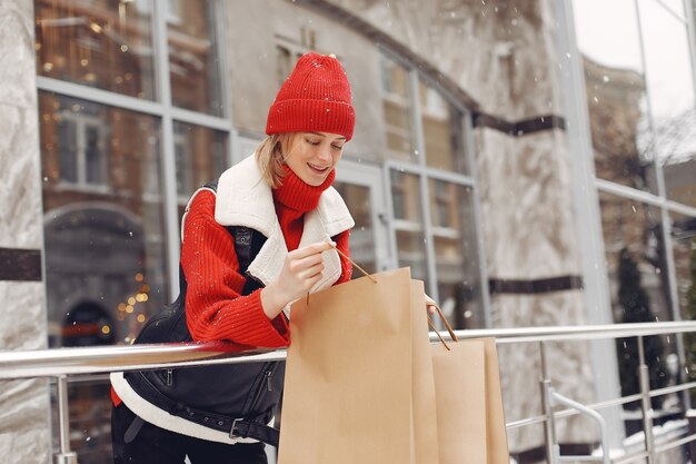 Woman carrying shopping bags at an outdoor shopping mall