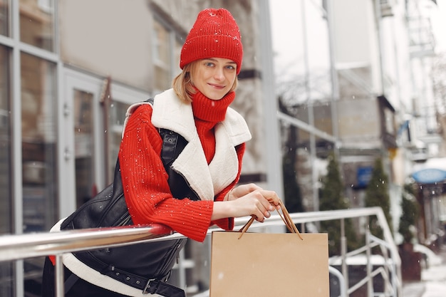 Woman carrying shopping bags at an outdoor shopping mall