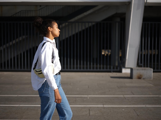 woman in casual wear walking around the city on a warm sunny day. Selective focus. Medium format shot