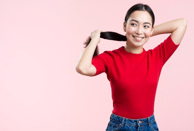 Woman catching hair in ponytail