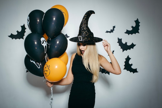 Woman celebrating Halloween with balloons