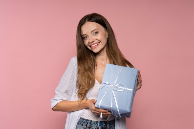 Woman celebrating while holding present