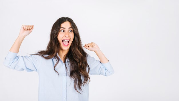 Woman celebrating with arms raised