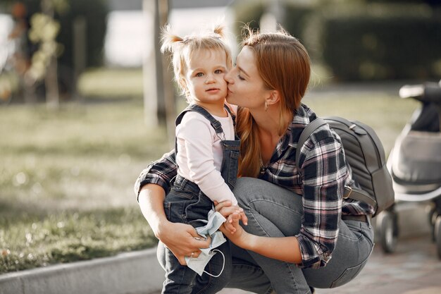 Woman in a cell shirt. Family on a sunlight background.