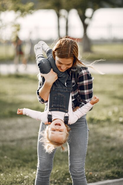 Woman in a cell shirt. Family on a sunlight background.