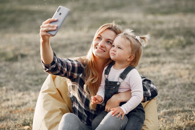 Woman in a cell shirt. Family on a sunlight background.